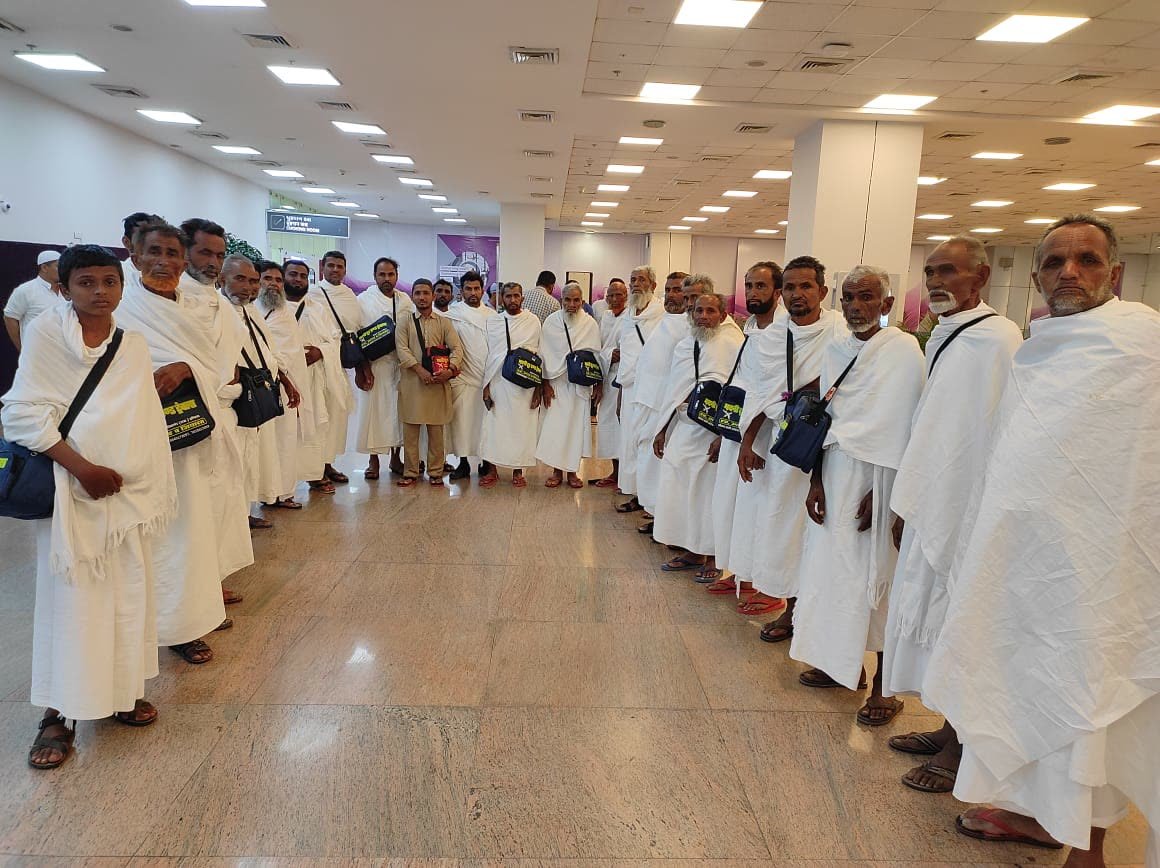 Pilgrims in ihram waiting together at the airport terminal