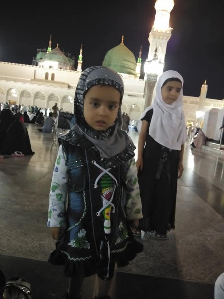Two children of a pilgrim family at Masjid an-Nabawi